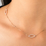 woman wearing marquise diamond necklace and rings